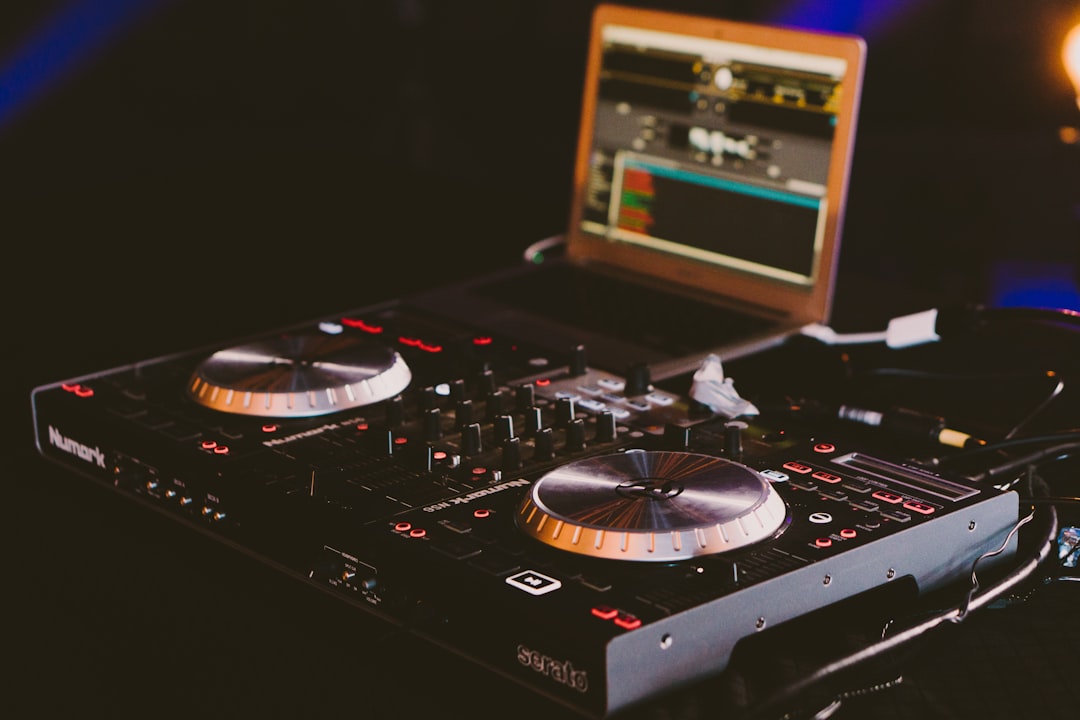 black-dj-turn-table-next-to-laptop-computer-oulvg5zkphi